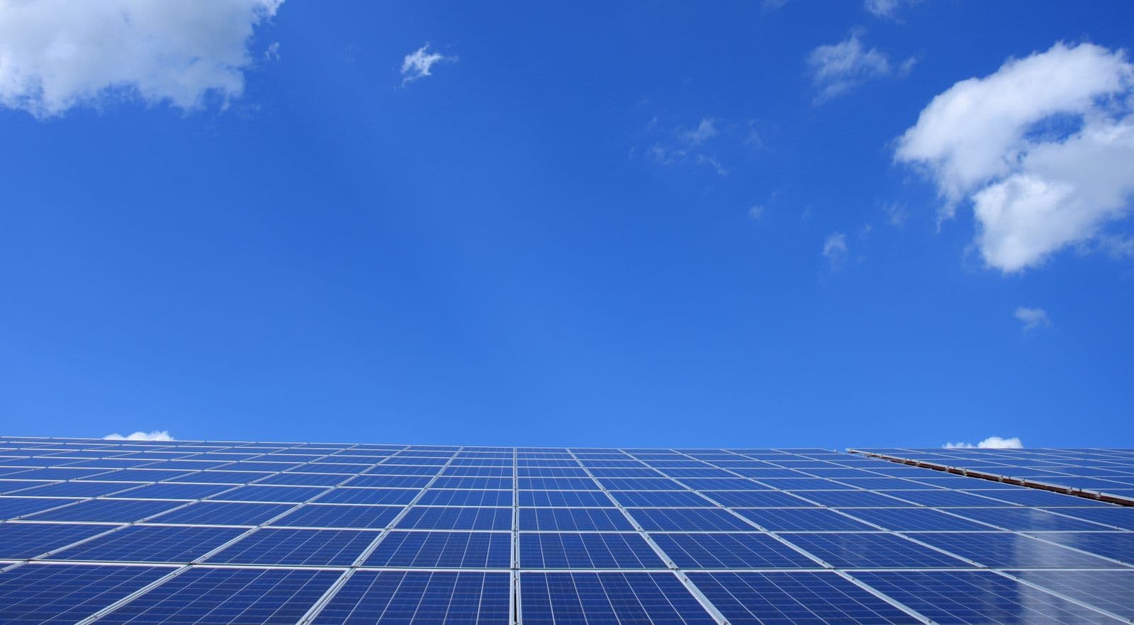 Rooftop solar panels under a clear sunny sky